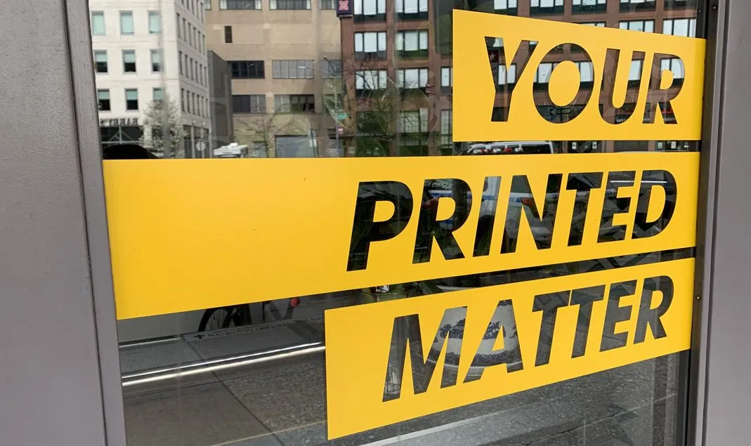 a yellow sign on a window